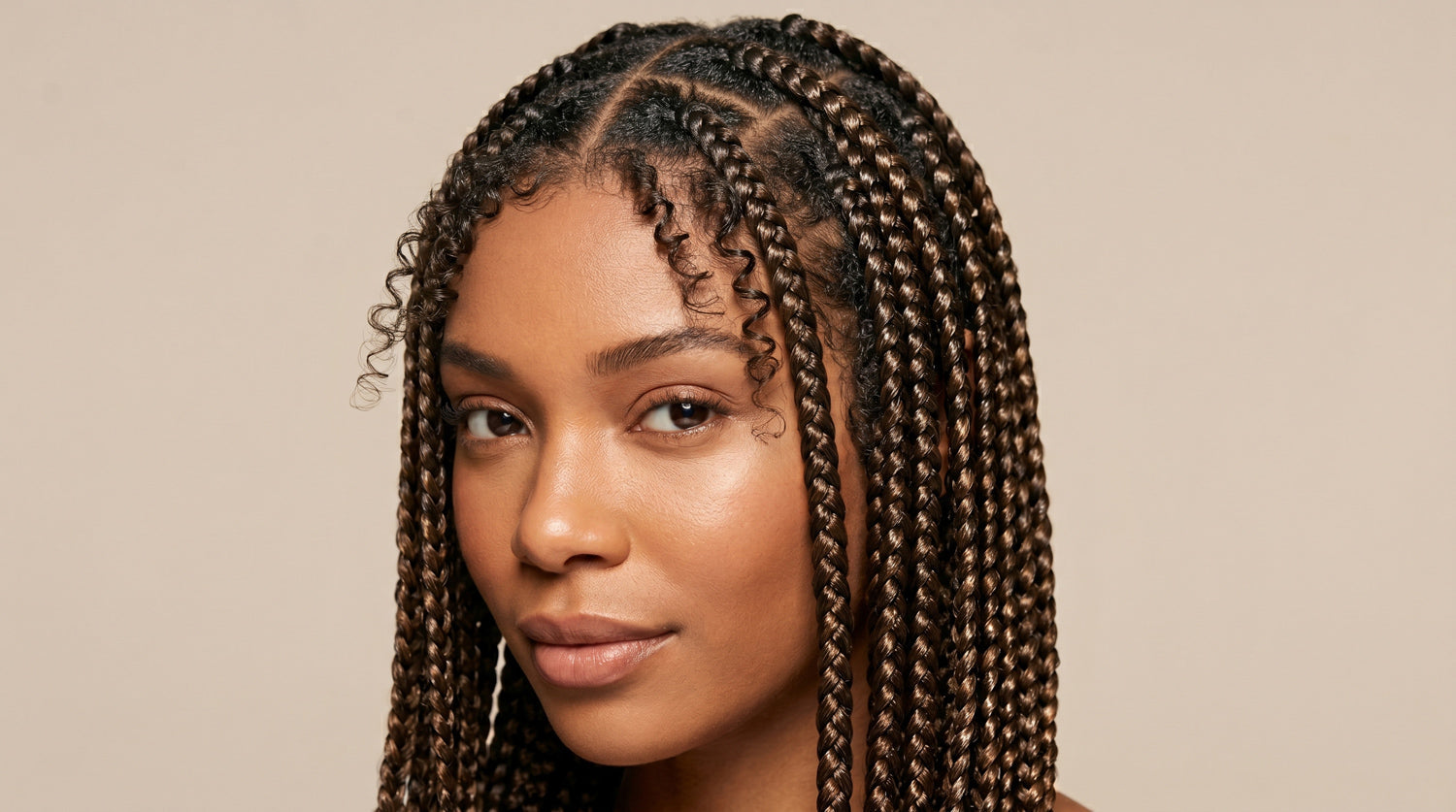 Close-up of neat box braids on textured natural hair with clean parts, smooth edges, and high shine, styled using strong hold braiding gel for frizz control and long-lasting protective style.