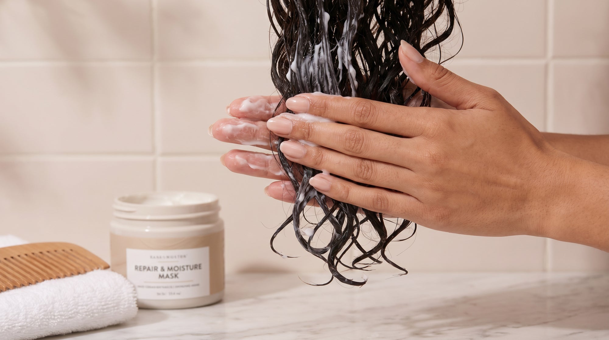 A woman with thin, dry hair applying hair treatment